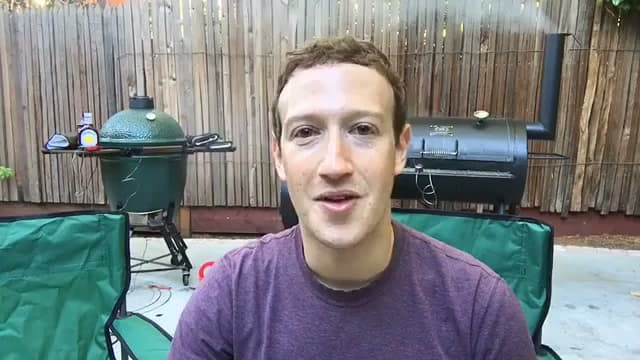Frame from the October 9, 2016 Facebook Live: the founder in a backyard in front of a smoker and a kamado grill